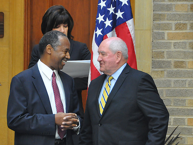 Ag Secretary Sonny Perdue greets Ben Carson, the secretary of Housing and Urban Development and a member of Trump&#039;s new Ag &amp; Rural Prosperity Task Force, led by Perdue. (DTN photo by Emily Unglesbee)